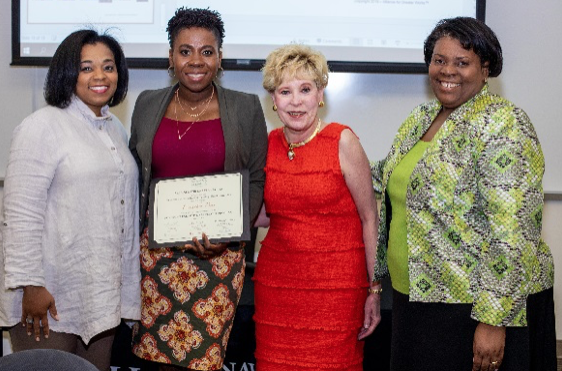 Earrecker Deer accepts her certificate of completion with Angela Johnson, Diane McNulty, and Sherrye Willis. 