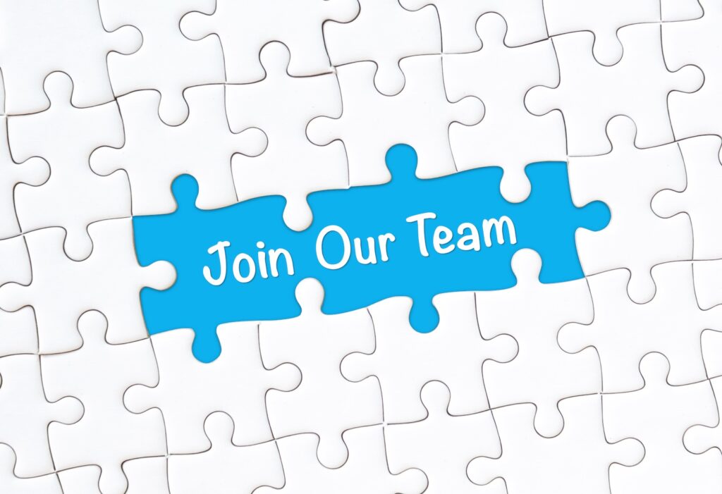 Puzzle with pieces spelling "Join Our Team"